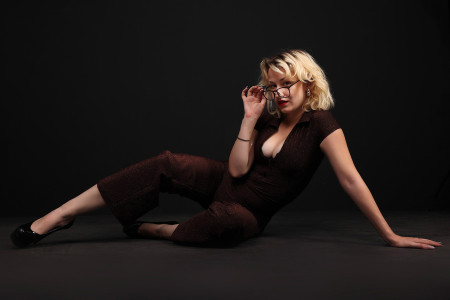 a woman with glasses sitting on the ground a woman with glasses sitting on the ground